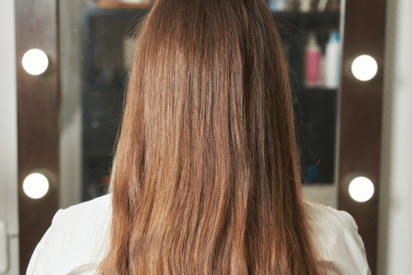 Brazilian Blowout Before image of the back of a woman's head with long hair.