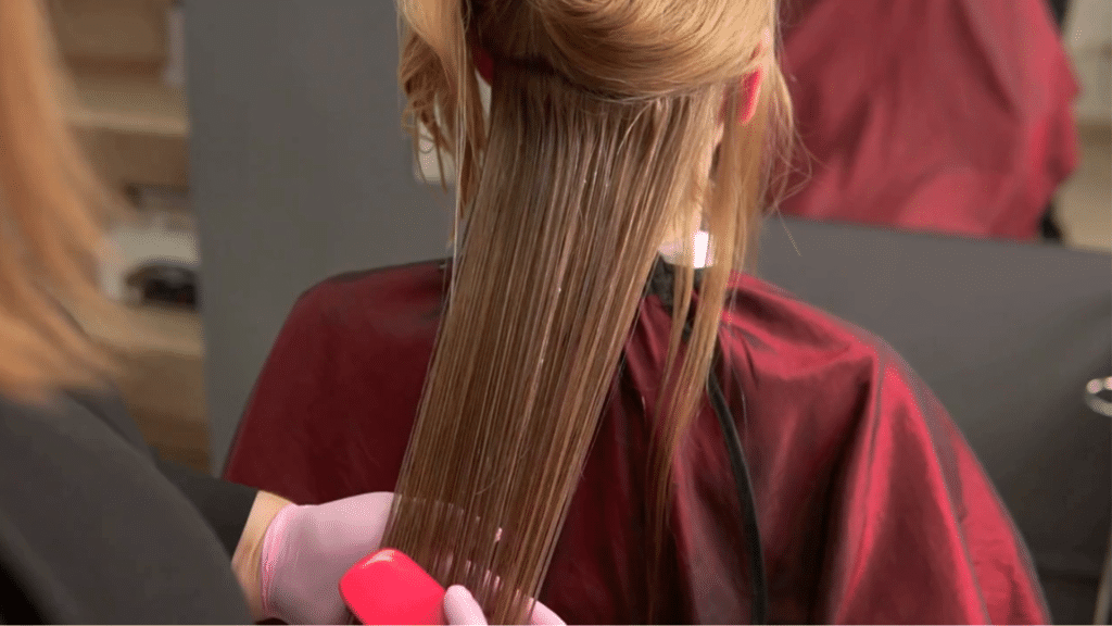Hair stylist brushing a woman's hair