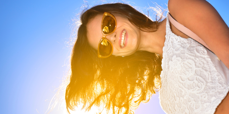 Summer Hair Care Woman with sun shining through her hair