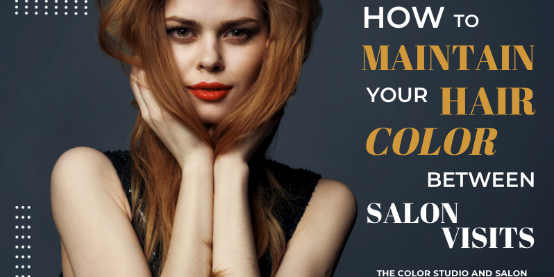 A confident woman with long, beautifully colored hair poses with her hands gently framing her face. The image promotes tips on how to maintain hair color between salon visits, featuring text that reads "How to Maintain Your Hair Color Between Salon Visits" and is branded by The Color Studio and Salon.