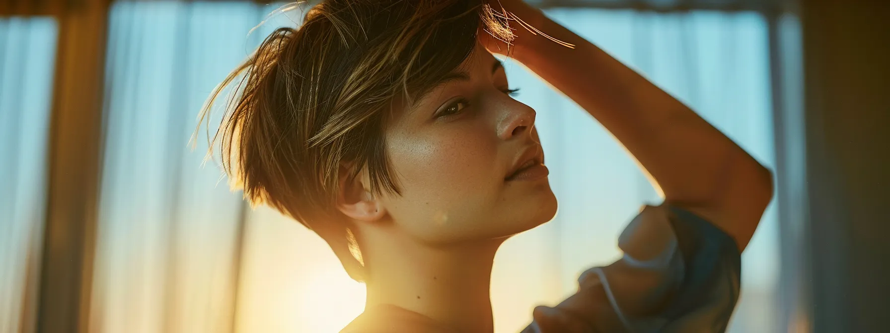 Effortless Short Hair Styling: Your Ultimate Guide 5 a woman confidently brushing back her perfectly styled short hair, showcasing a sleek and polished look.