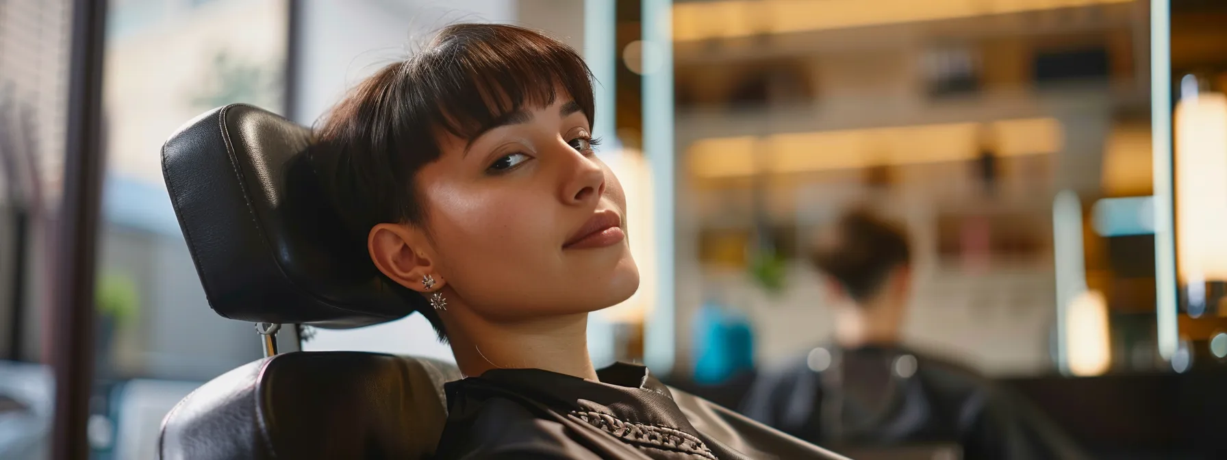 Revamp Your Look With Women's Fade Haircut Ideas 1 a woman sitting in a modern salon chair, with a perfectly styled and fresh fade haircut, showcasing a sleek and stylish look