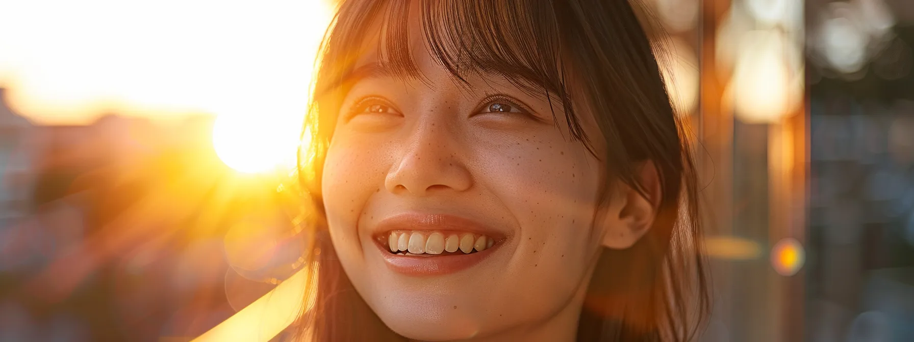 Stylish Long Haircuts with Bangs and Layers for a Trendy Look! 2 a woman with heart-shaped face smiling confidently with soft, side-swept bangs framing her features.