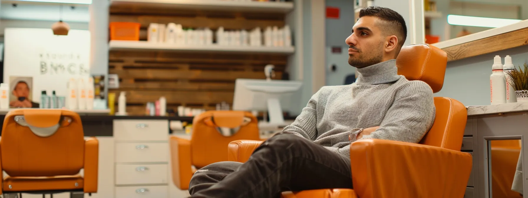 Mastering Fade Haircut Maintenance: A Comprehensive Guide 5 a man sitting confidently in a salon waiting room with a faded hair style waiting to have his fade touched up