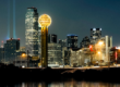 Skyline of downtown Dallas in the evening with the Reunion Tower ball displaying all white lights